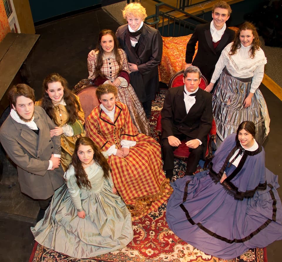 The full company in Civil War-era costume gathers around an antique sofa for a curtain-call portrait — Little Women, spring 2014.
